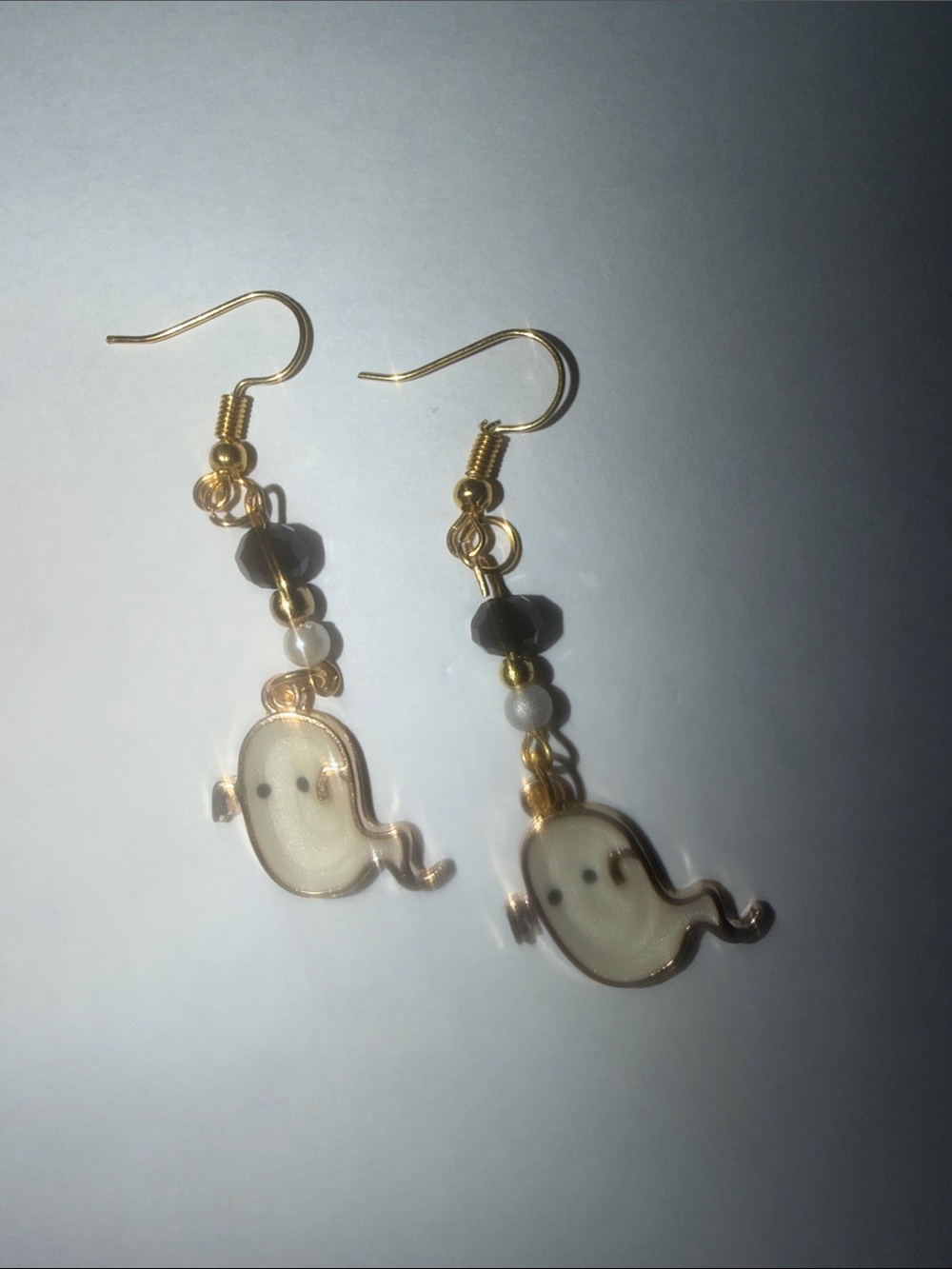 Gold-Tone Cream Ghost Drop Earrings with Black Bead Accents